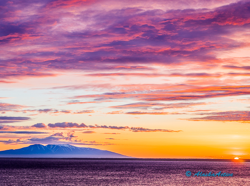 High-quality outdoor gear and layered clothing prepared for an Alaska hike